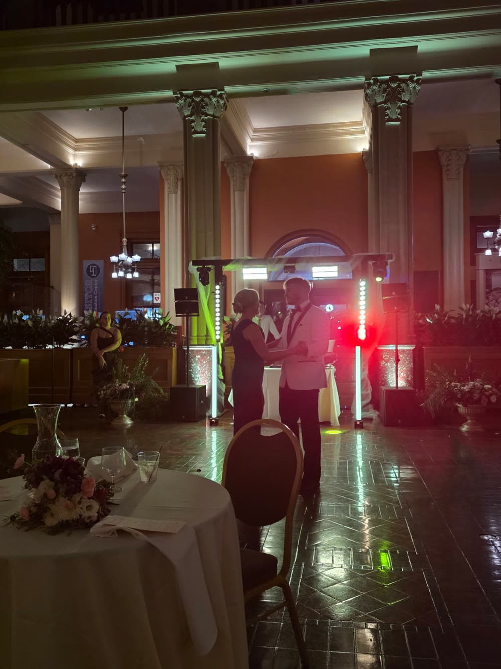 Couple dancing in a grand hall with LED production rig behind them
